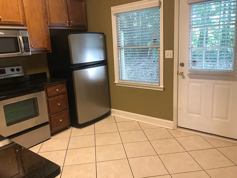 A large window and kitchen door offer great light. The kitchen door opens out onto the private patio.