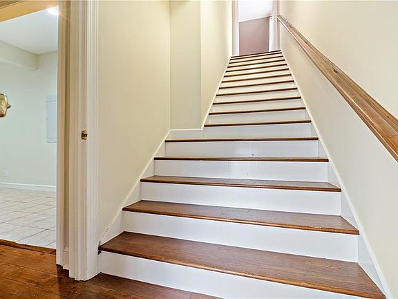 Stairwell to apartment. Entry door is behind and door to shared laundry is to the left