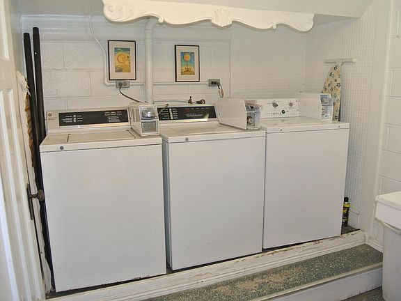 Three washers and two driers in Laundry Room