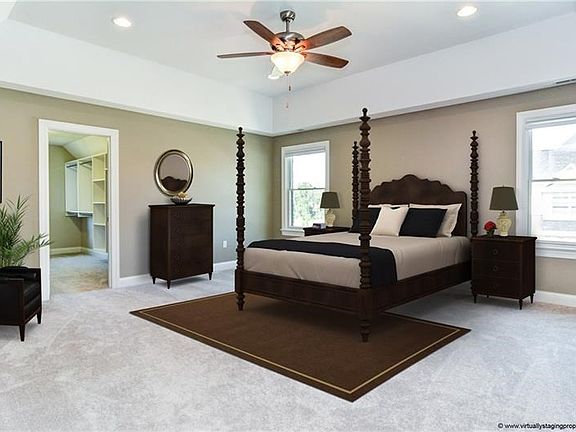 This lush master suite features a tray ceiling lighted by recessed lighting and a ceiling fan.  The large walk-in w/closet organ