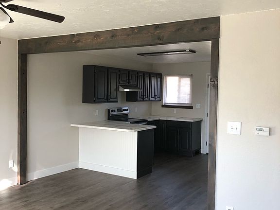 Photo taken from entryway through, looking at living room and kitchen