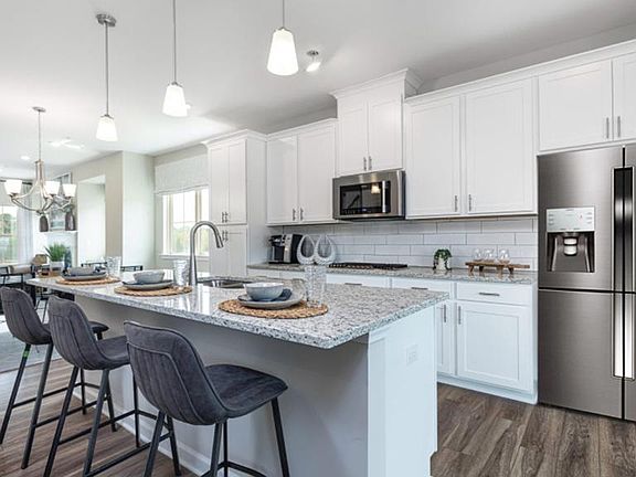 Kitchen has additional cabinets and extended counter top, added as an upgrade.