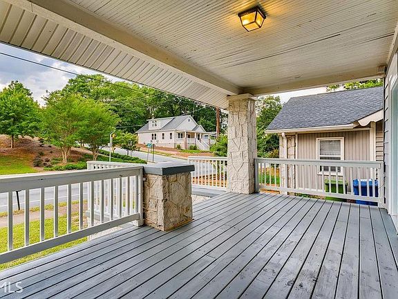 Huge front porch waiting for rocking chairs and a swing