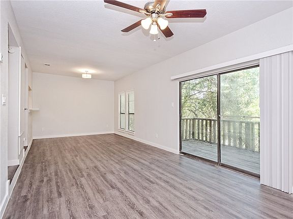 Living room view 2 showing 1st floor balcony entrance to overlook greenbelt.