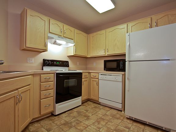 Kitchen with stove, dishwasher, refrigerator, and water purifier faucet