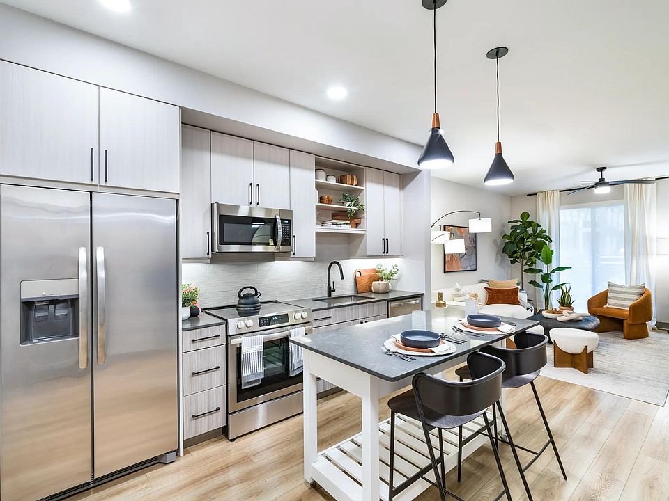 Modern kitchens feature stainless steel appliances, quartz countertops, and oversized islands perfect for entertaining or casual dining.
