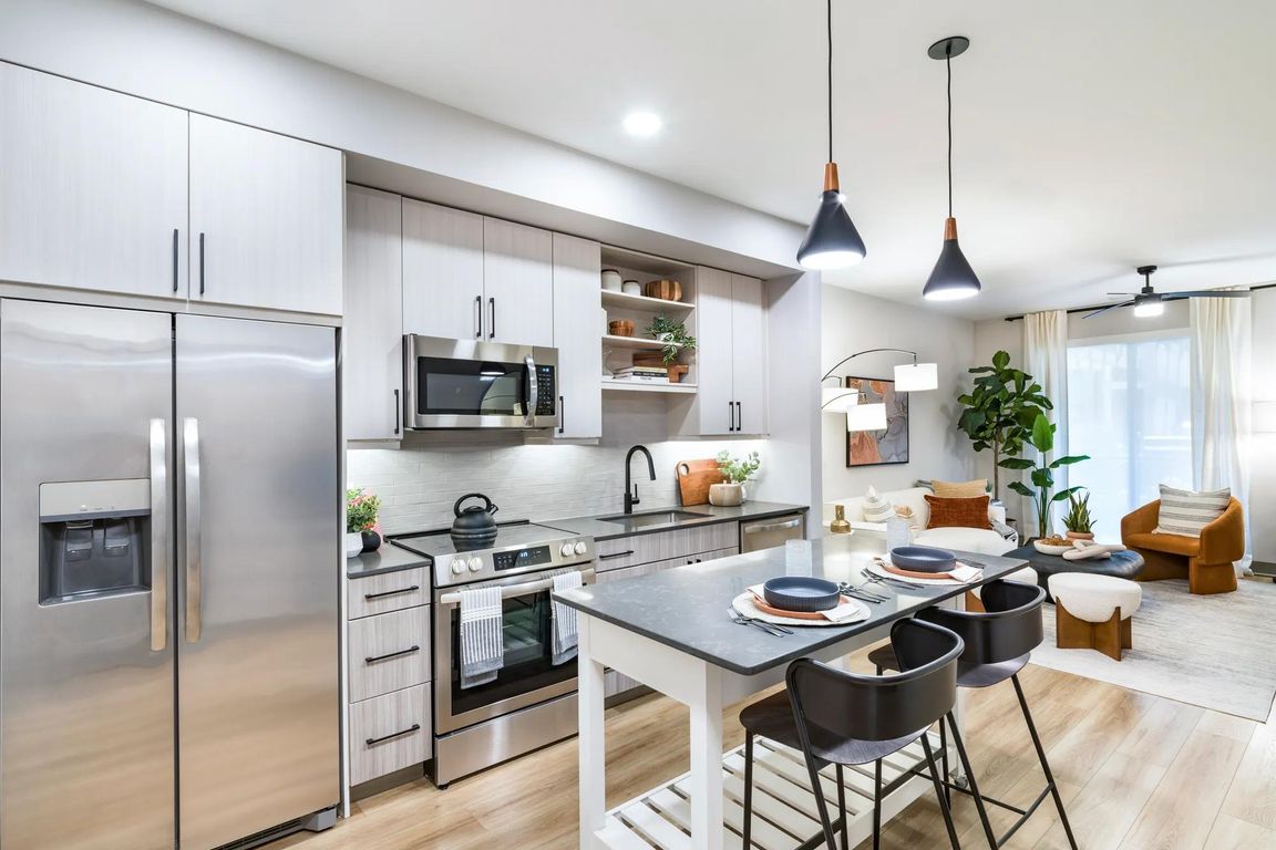 Modern kitchens feature stainless steel appliances, quartz countertops, and oversized islands perfect for entertaining or casual dining.