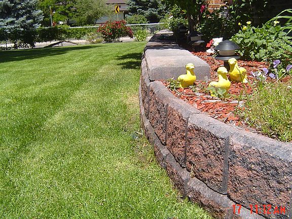 Added fully caped retaining wall--front to back