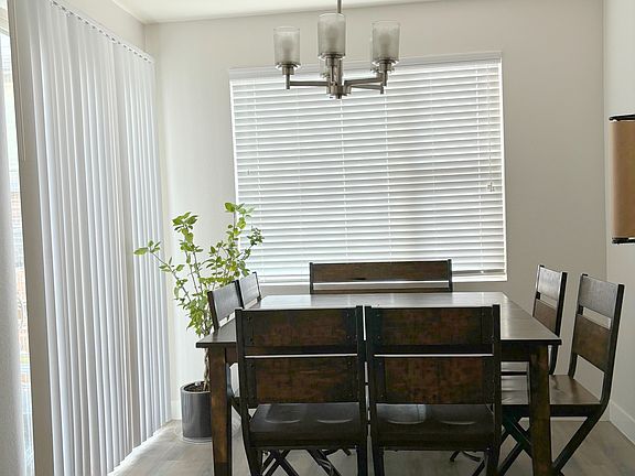 Dining area with view of patio blinds leading to patio. West facing room.