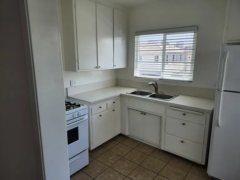 Large Kitchen has two windows! Refrigerator, range included.