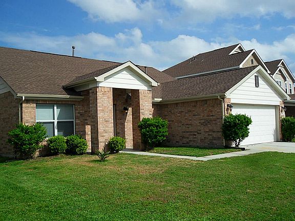 Side view of the front of the home shows the bricked entrance over the front door.