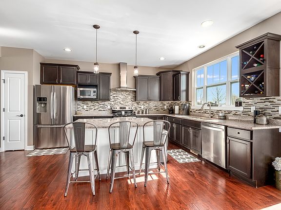 Granite, Recessed lighting, wine rack, spacious island and dual pantries.