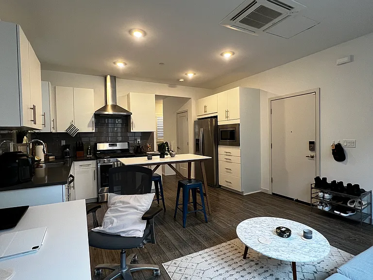 Work space, living room, dining and view into kitchen and front door