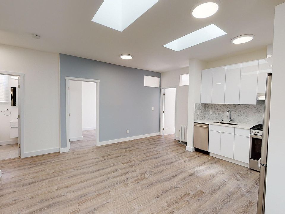 Living room with a wood-like flooring and a view of the kitchen