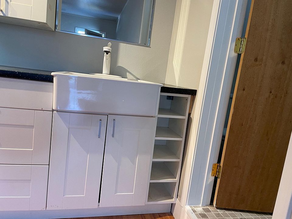 Kitchen sink and door into bathroom