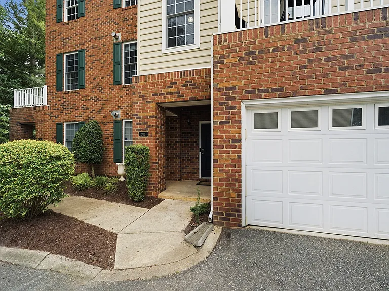Front porch, garden, sidewalk, garage and parking area