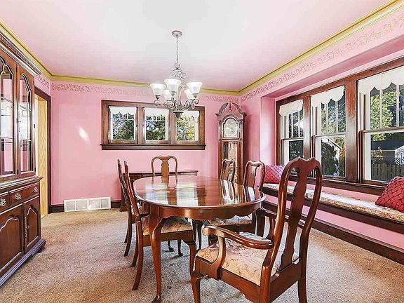 Leaded glass built ins and a large window seat are some of the features of the formal dining room.