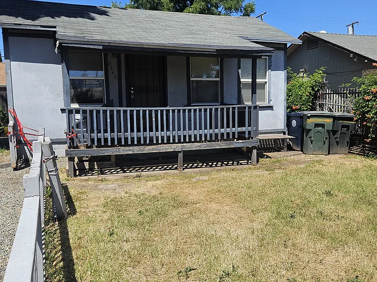 Shady front porch with screened security door.
