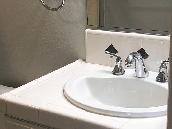 Upstairs bathroom with tub enclosure