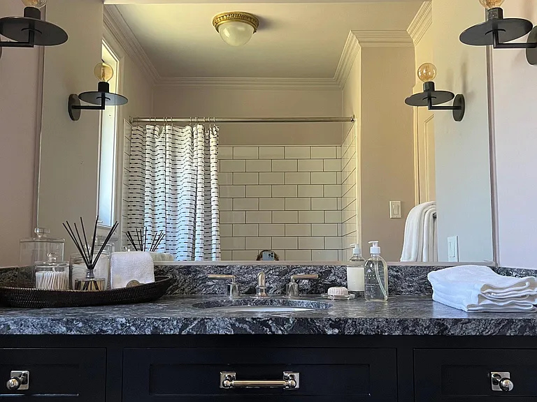 Hall Bathroom services Green and Yellow bedrooms; outfitted with tub shower and custom single vanity.