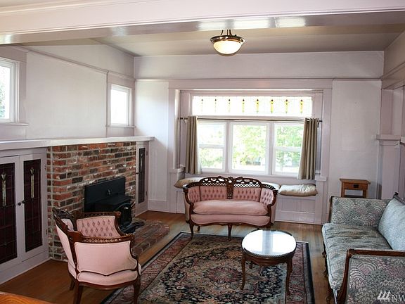 Living Room With Wood Stove & Hardwood Floors