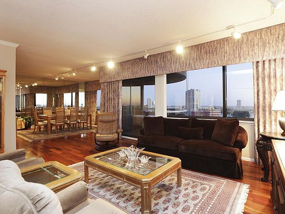 Open Concept Living & Dining Rooms with First of Two Balconies Beyond
