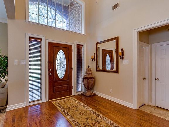 Dramatic entrance foyer with large windows, high ceilings, and lots of windows.
