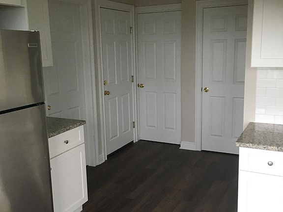 Kitchen looking to doors to attic (far left, pantry middle, bathroom right