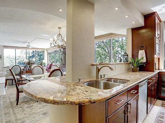 Kitchen has Granite Counter Tops and Bar Area.