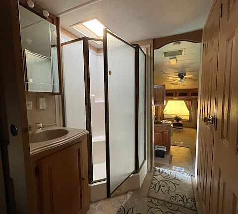 hallway shows bathroom area/shower
