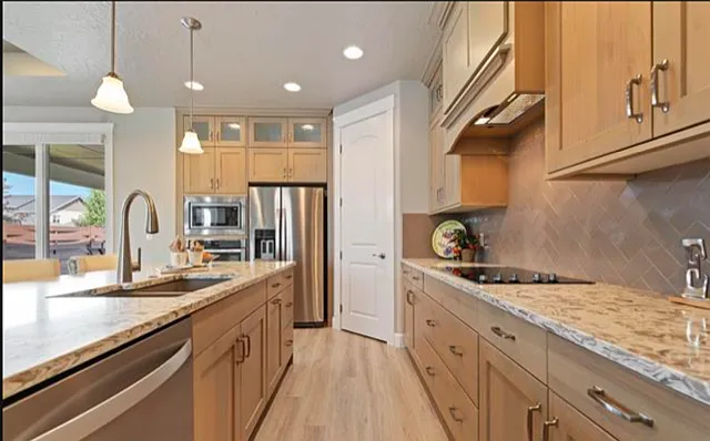 KITCHEN WITH CORNER PANTRY AND FOUR BURNER ELECTRIC RANGE.
