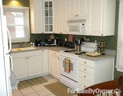 Kitchen : Corian Countertops and sink.Tile floor. Eat-in. new cabinets 2 with glass fronts