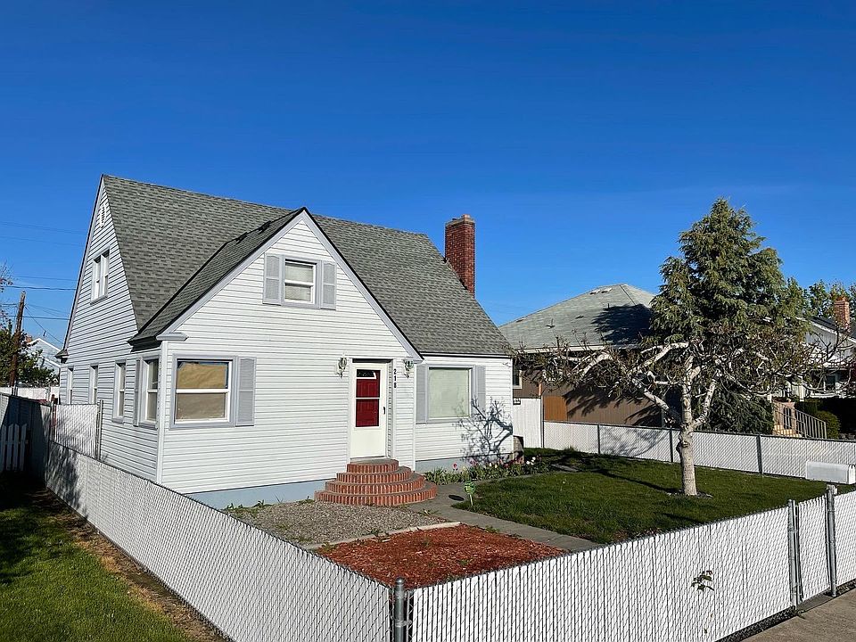 Front of the home - there is a fenced front yard with a gravel space for an outdoor table space and grassy area for renters to enjoy.