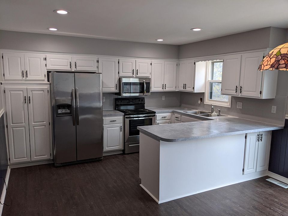 Kitchen with brand new fridge, stove, microwave and dishwasher