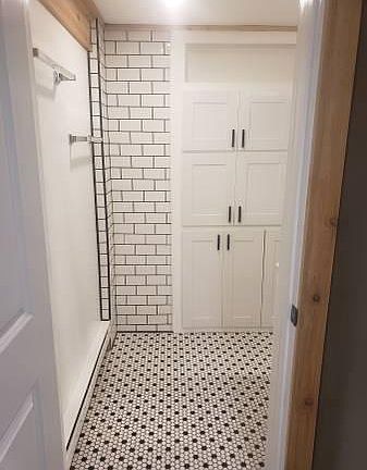 Bath entrance with a look at the built-in bathroom cabinet storage.