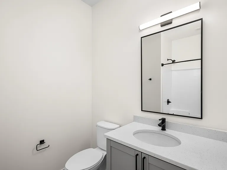 Modern bathroom with sleek vanity, elegant mirror, and bright lighting for a refreshing ambiance. Modern bathroom with sleek vanity, elegant mirror, and bright lighting for a refreshing ambiance.