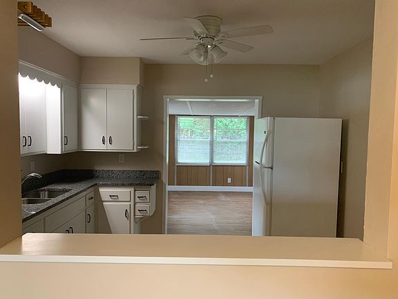 View of kitchen from living room looking into bonus room
