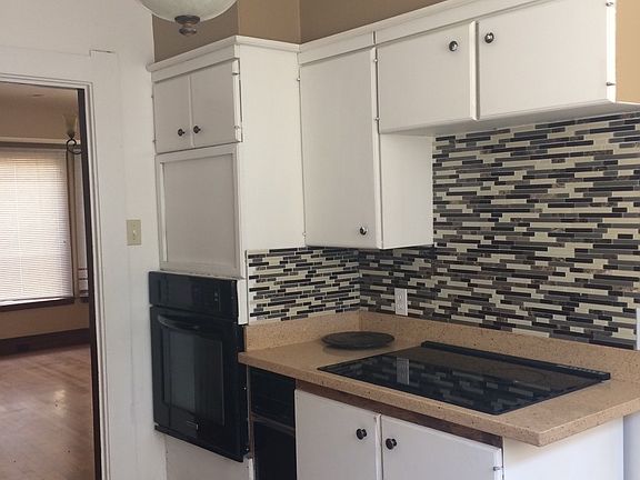 The kitchen has updated backsplash tiles all around.