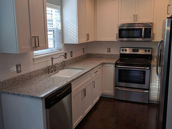 Kitchen - white shaker style designed cabinetry
