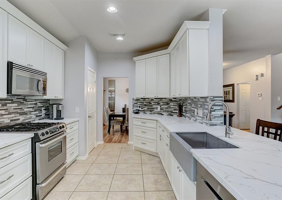Recently remodeled kitchen boasts quartz countertops, soft closing cabinets and drawers, new hardware, and a quartz sink.