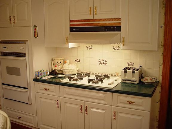 1st view of main level kitchen, also has a bay window next to the table.