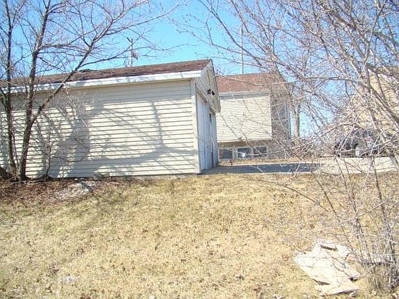 Huge grassy yard on the side of garage.