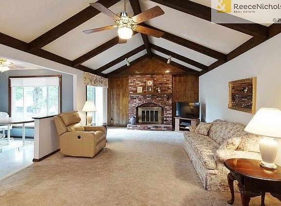 Great Room w/wood burning fireplace perfect for entertaining family and friends, entrance to tiered deck through sliding glass door.  Open kitchen to the left.
