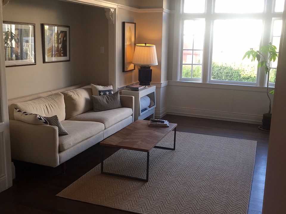 Living room, flooded with natural light from the backyard