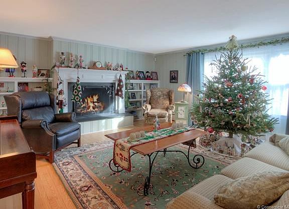 Generous formal living room with builtins and propane fueled fireplace. Hardwood floors, crown molding. All hardwood floors are in excellent condition and well kept.