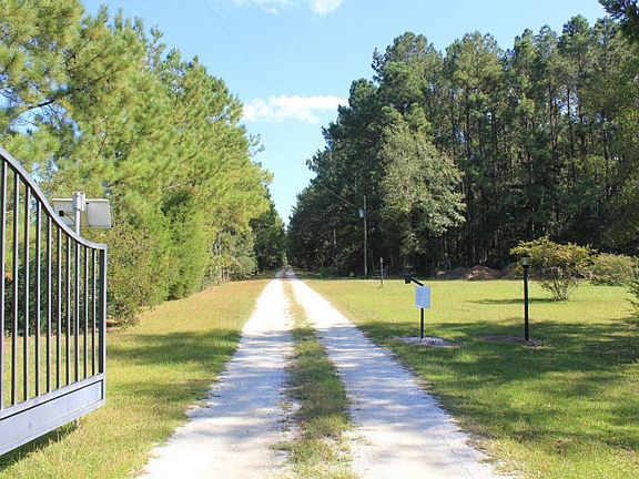 Crushed limestone and lighted driveway lead back to the house and greenhouses.