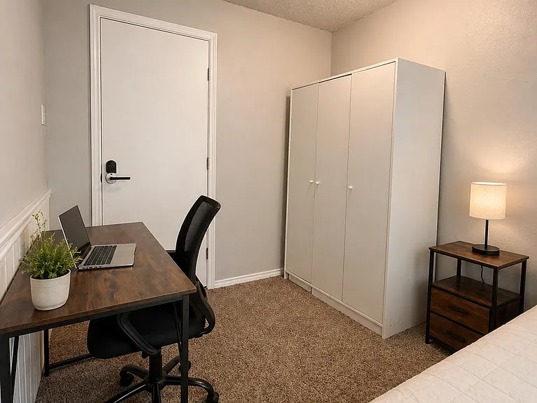 Bedroom includes a work desk setup, wardrobe storage, and bedside table with lamp for comfortable everyday living.