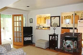Living area with working pellet stove and open to the kitche