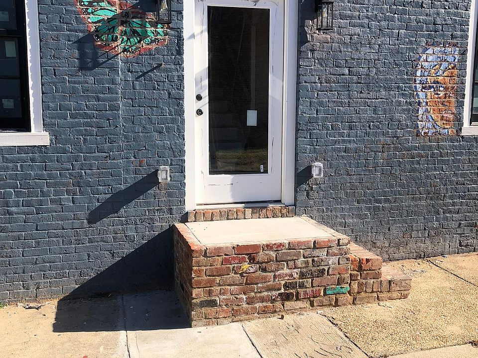 Apartment entrance on the side of the space. We kept some of the quirky murals from before the renovation.