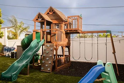 Spacious backyard packed with fun! Comfortable lounges, gather around the fire pit, cook on the pizza oven or BBQ, play the giant chess set, enjoy the playground, or watch movies on the large projector screen. Endless ways to play and unwind.
